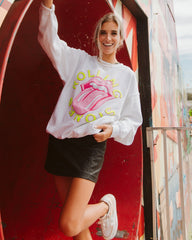 Girl with blonde hair is smiling and wearing a Rolling Stones Neon Puff Classic Lick White Thrifted Sweatshirt.